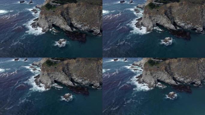 美丽的俯视图无人机拍摄了加利福尼亚大苏尔岩石悬崖海岸线上令人惊叹的深蓝色海浪。