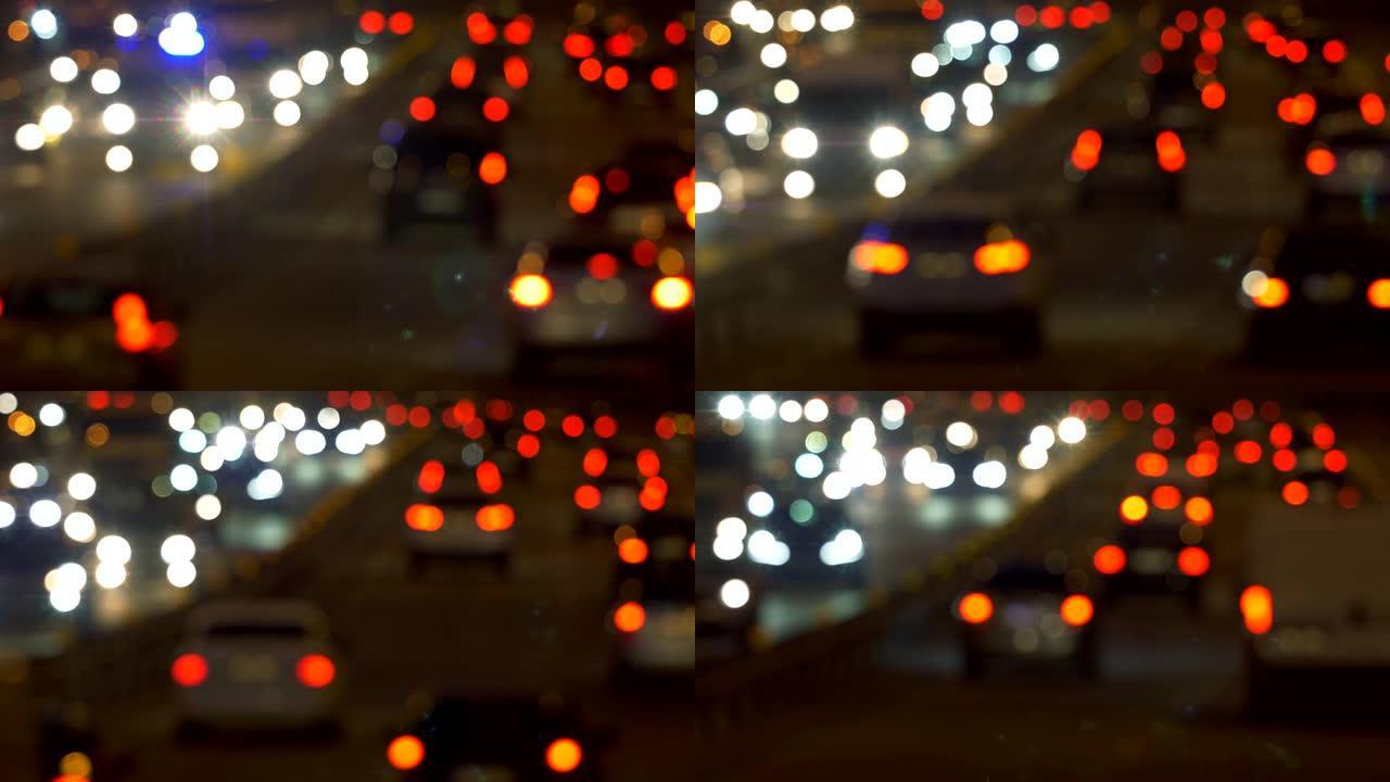 汽车在晚上上路。抽象未聚焦的红色、黄色和白色灯光。4K
