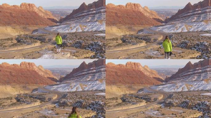 无人机: 女摄影师观察在砂岩地层下行驶的高速公路
