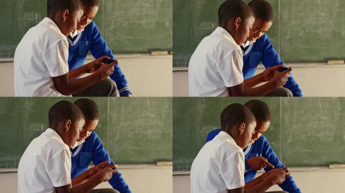 小学生在乡镇学校4k休息时使用智能手机