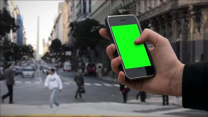 在布宜诺斯艾利斯，男性双手握着带有绿屏的旧智能手机。
