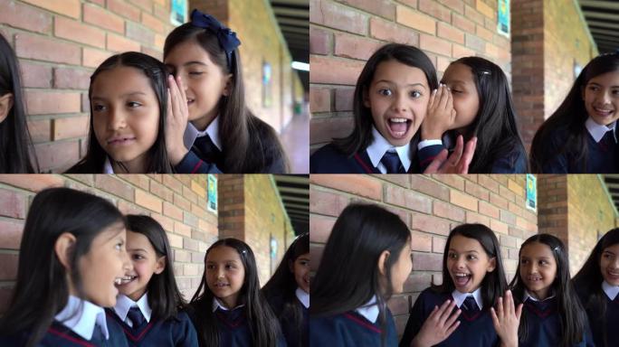 拉丁美洲女孩在学校讲秘密，看起来很开心