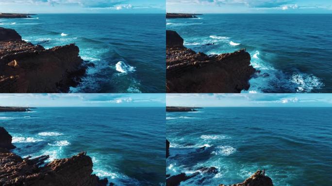 空中无人机镜头: 葡萄牙岩石海岸，海景优美。飞越葡萄牙，海岸线上海浪滚滚，坠入悬崖。孤独的渔夫正在钓