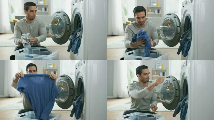穿着灰色牛仔裤和外套的英俊严肃的年轻人坐在家里的洗衣机前。他给洗衣机装上脏衣服。明亮宽敞的客厅，室内