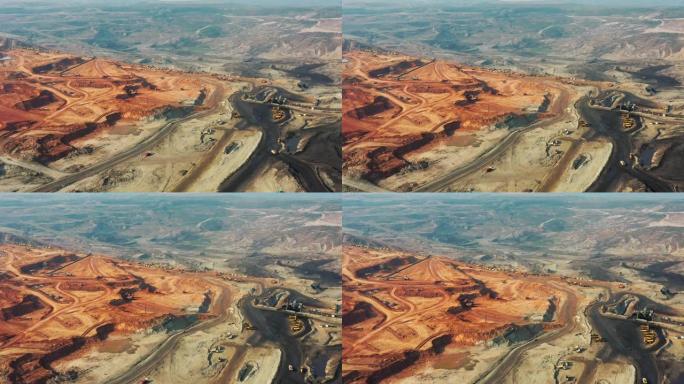 大型矿车在露天采石场中工作的矿井的一部分的鸟瞰图，在露天采石场装载推土机