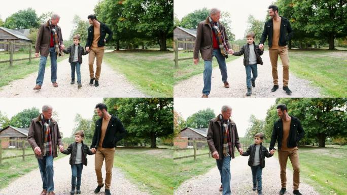 祖父带着儿子和孙子一起在乡下散步