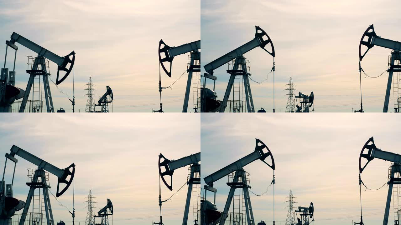 有几个油井架的汽油开采地点。石油工业，石油工业，石油部门概念。