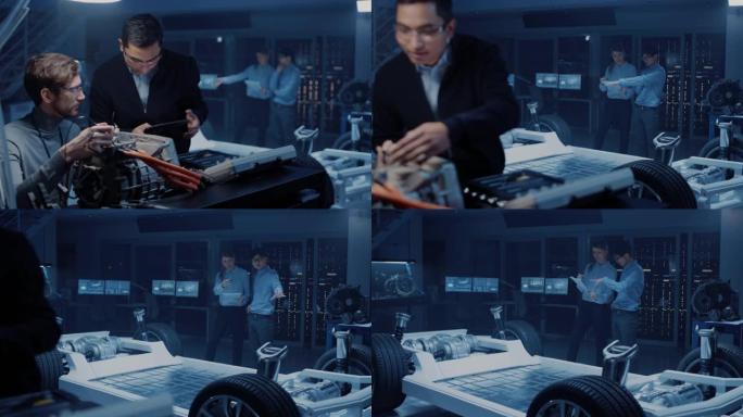 两名拥有平板电脑和检查工具的专业汽车工程师正在与概念车底盘的高科技实验室中测试电动发动机时进行对话。