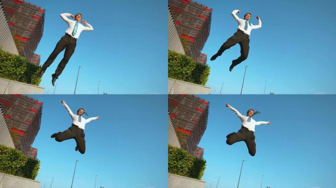 低角度: 成功会面后，运动商人在空中跳高。
