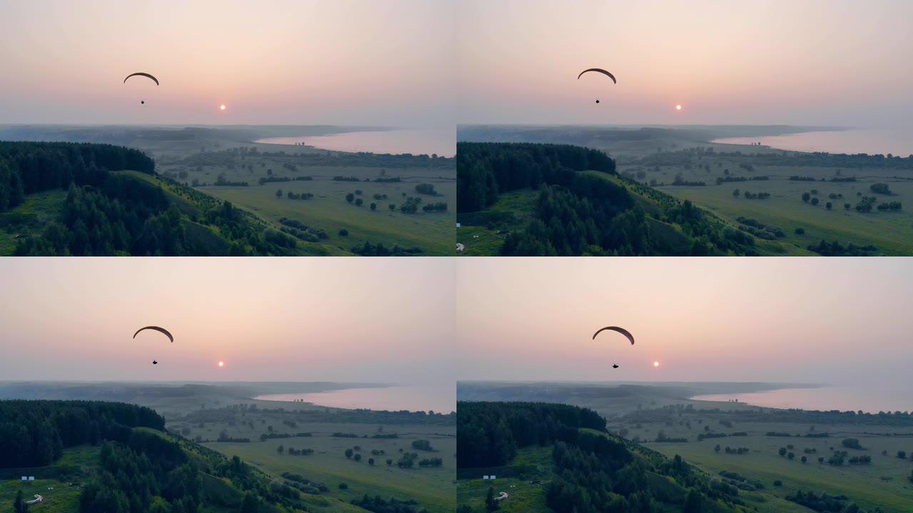 滑翔伞车辆漂浮在日落地平线上