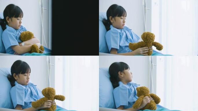 亚洲小女孩独自躺在医院拥抱玩具，不快乐的孩子失踪父母，疾病和治疗。