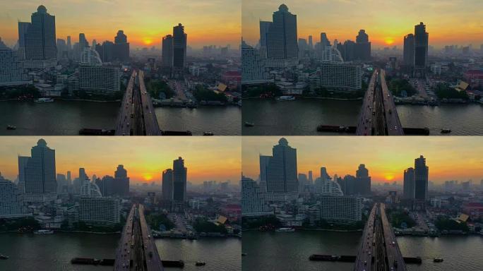 日出时，曼谷市对湄南河，BTS天空火车和Charoen Krung路上的Taksin桥的空中射击