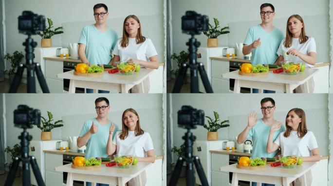 几个博客作者在厨房录制视频，显示竖起大拇指挥舞的手