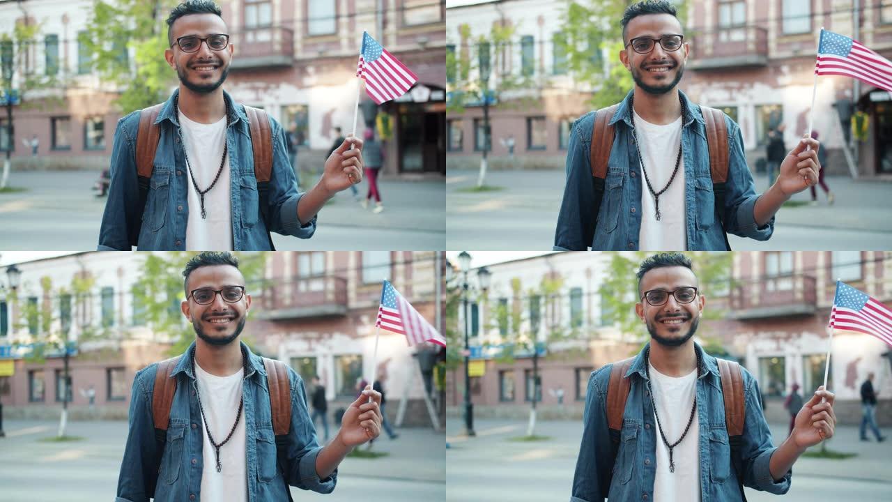 阿拉伯学生在街上举着美国国旗微笑的肖像