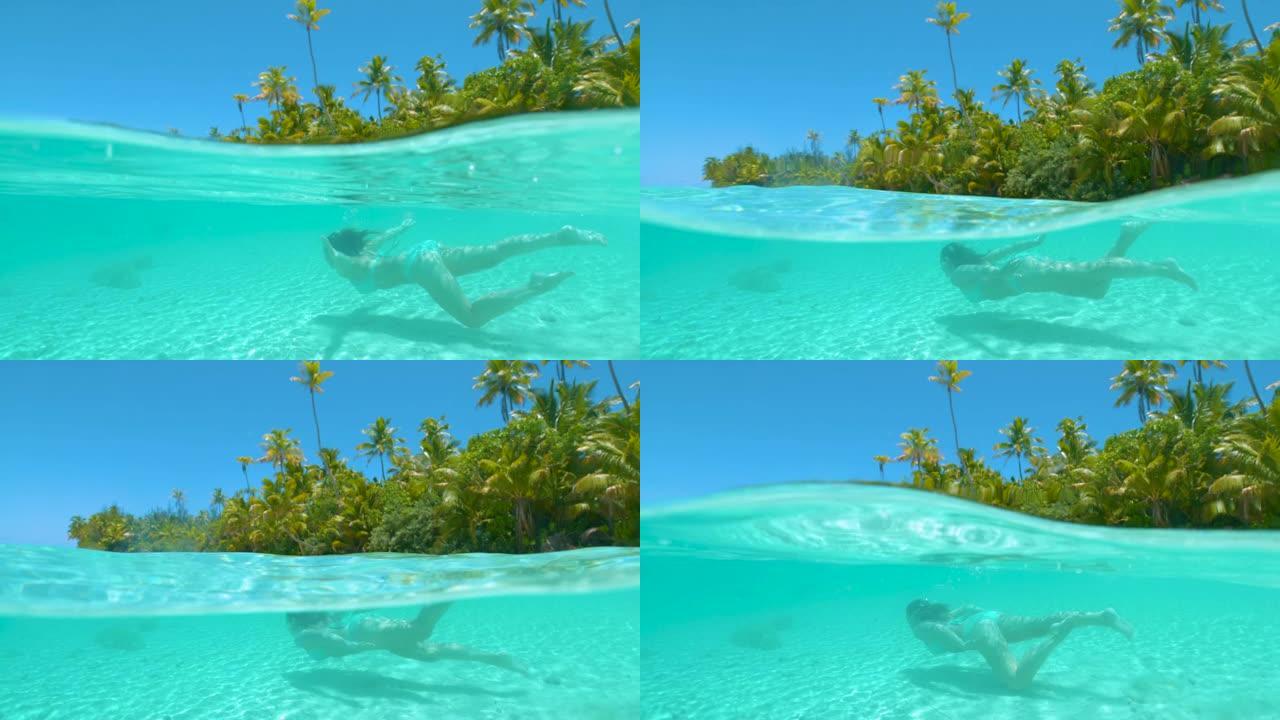 慢动作: 快乐的女游客在天堂岛海滩附近潜水。