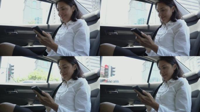 聪明的女商人在汽车上使用电话
