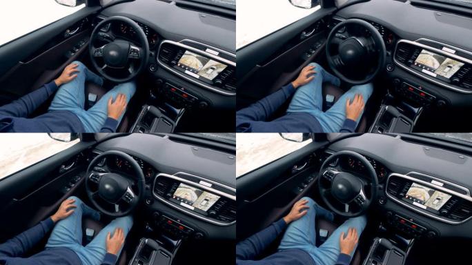 男子坐在自动驾驶仪上的汽车，当它停车时，俯视图。