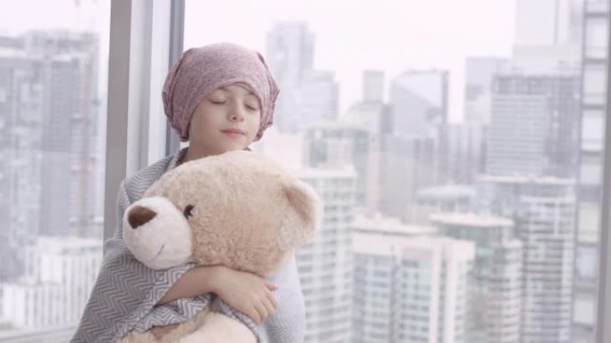 一个拿着毛绒玩具的癌症女孩的肖像