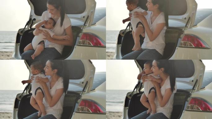 快乐的亚洲母亲和男婴坐在车上。暑假期间，父母和人们积极与婴儿一起户外活动。家庭享受公路旅行和暑假。假