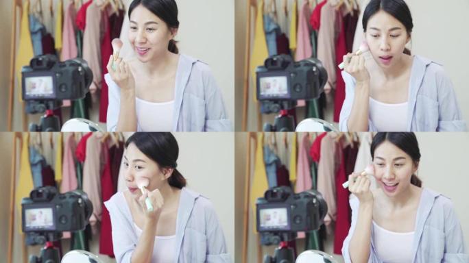 慢动作: 亚洲年轻女性博客作者在家中录制带有化妆化妆品的vlog视频。有影响力的女人在线直播病毒。