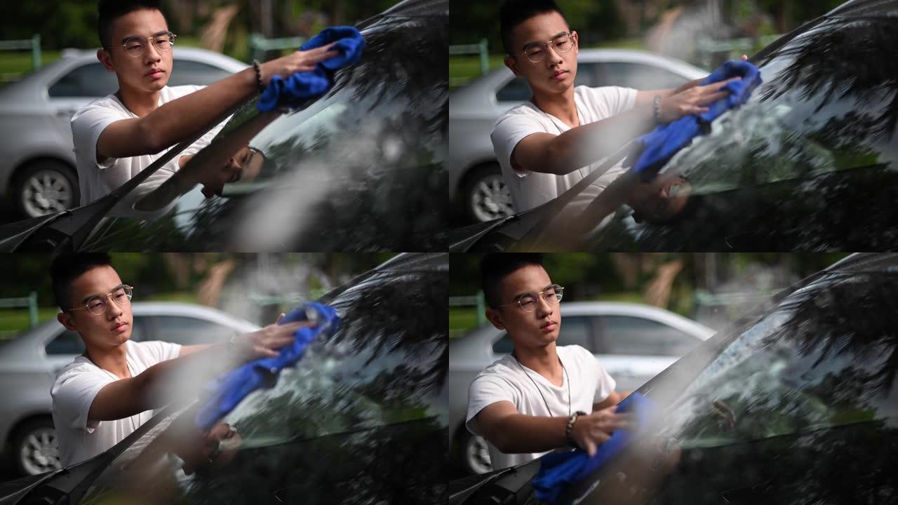 一个亚裔中国少年在他的房子前洗车