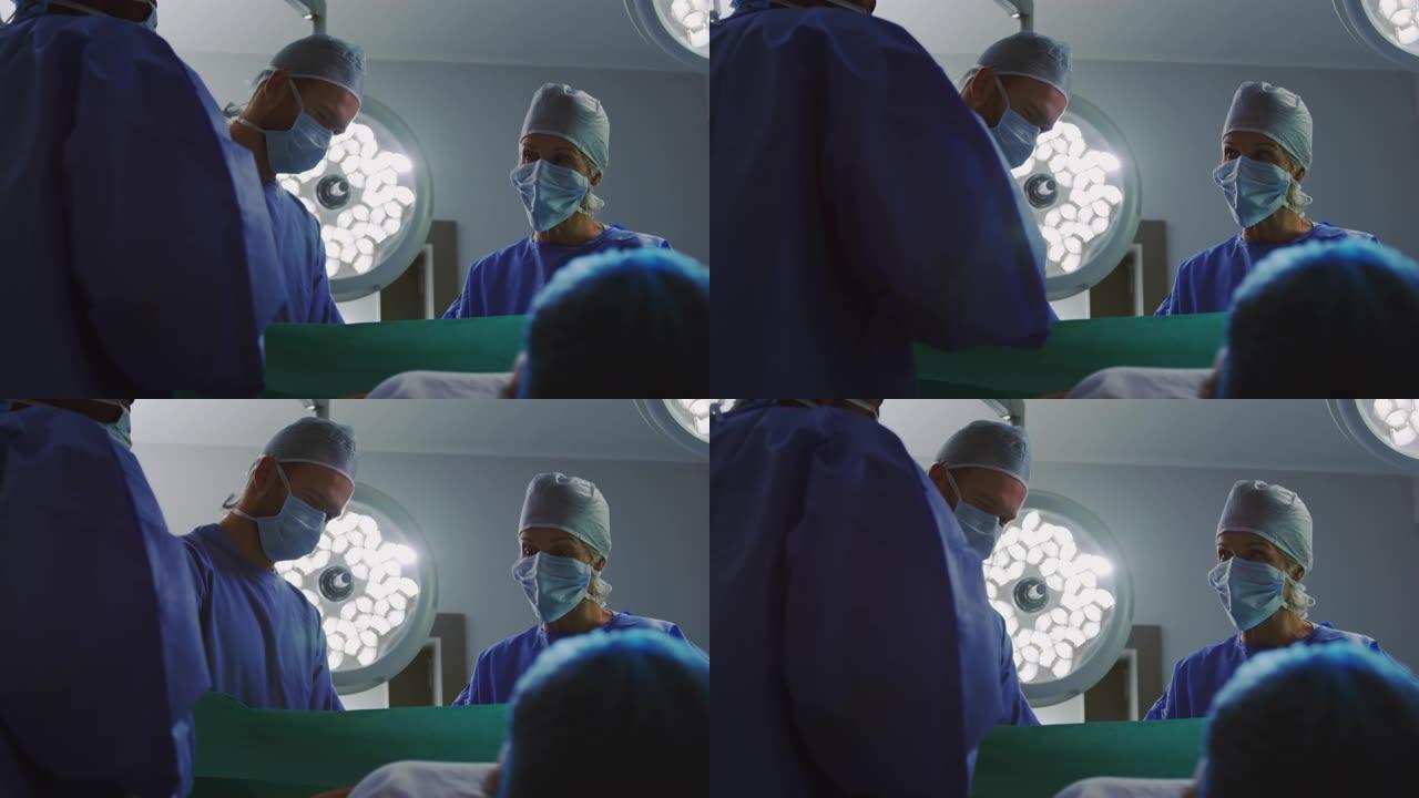在手术室4k中操作孕妇的外科医生的低角度视图