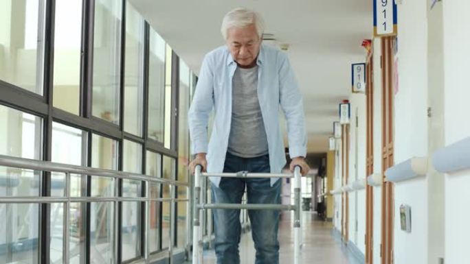 亚洲老人在走廊上使用助行器行走