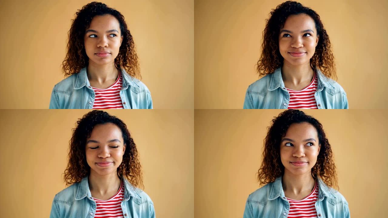 可爱的非洲裔美国女孩翻白眼微笑的特写肖像