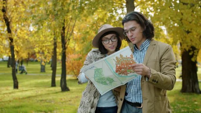 幸福的夫妇用智能手机拍照并检查户外旅行的地图