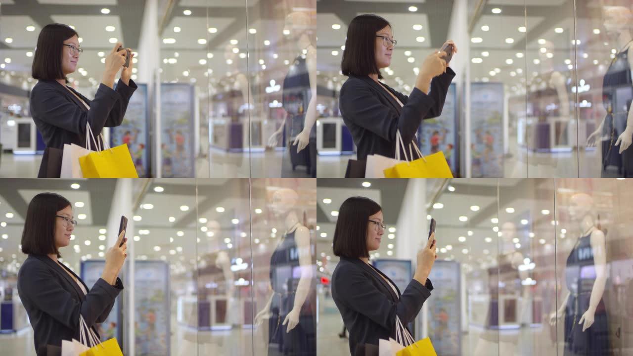 韩国妇女在商店橱窗里在人体模型上拍照