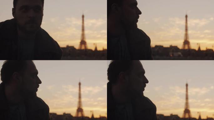 体贴的欧洲年轻人的特写日落肖像直视巴黎埃菲尔铁塔天空风景慢动作。