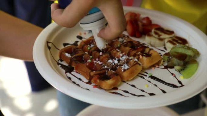 Pouring syrup on a waffle