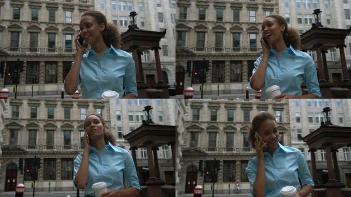 美丽的黑人女商人在外面享受咖啡去接电话微笑