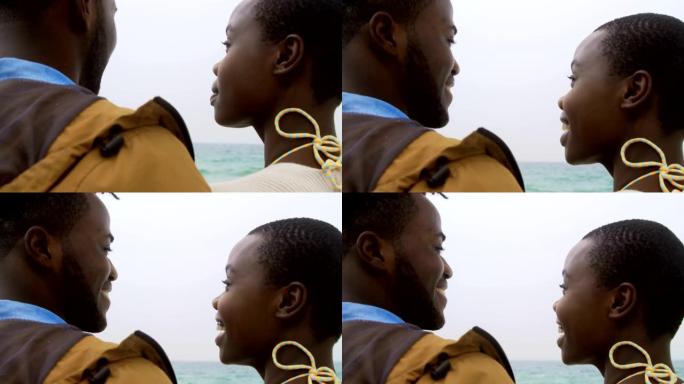 非洲裔美国夫妇站在海滩4k的后视图