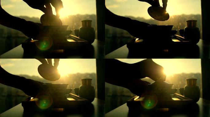 喝中国茶和日落阳光逆光功夫茶陶瓷器轻抚茶
