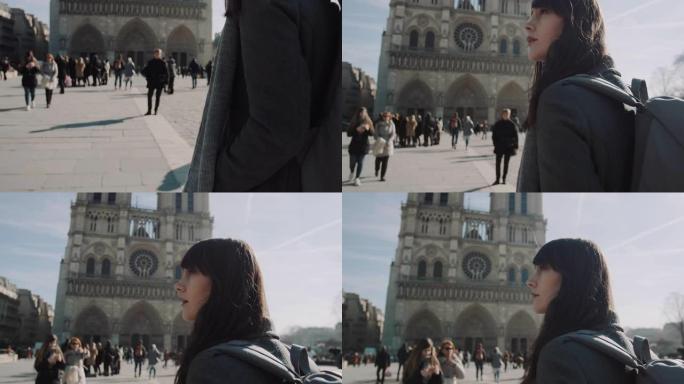 电影向上倾斜，美丽的女人带着背包在阳光明媚的秋日慢动作沿着巴黎圣母院行走。