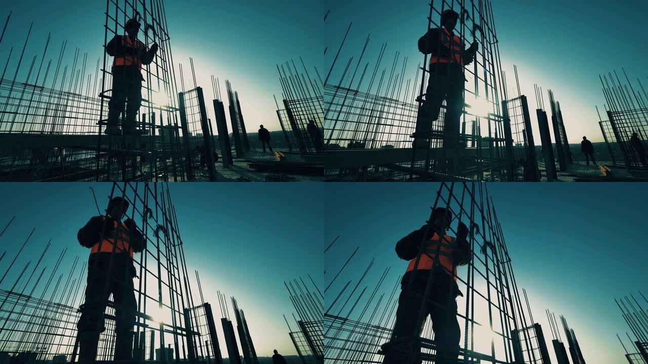 承包商，建筑工人在建筑物上固定钢筋。