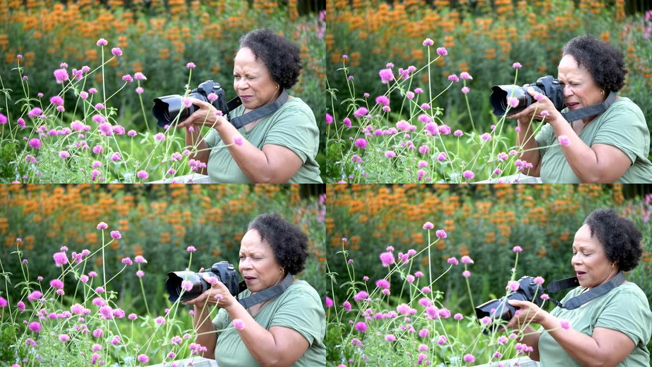 拍摄鲜花的非裔美国高级妇女