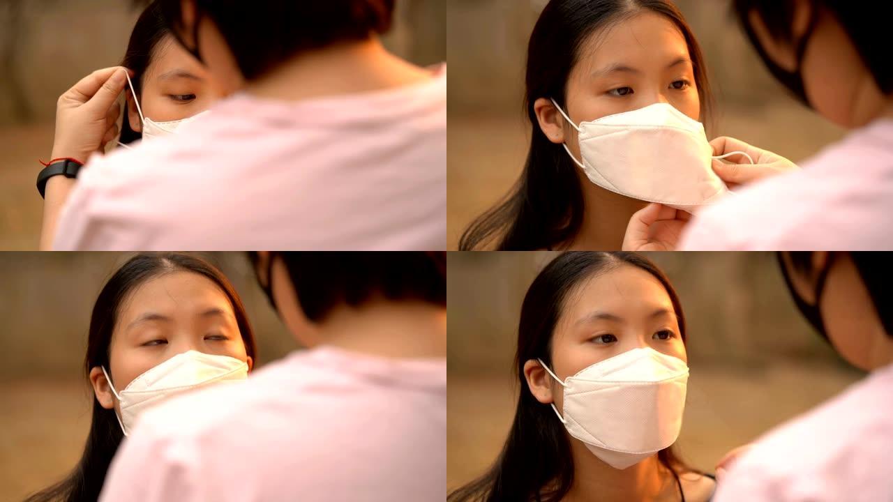 手持慢动作拍摄妈妈护理女儿脸上戴着空气污染面具