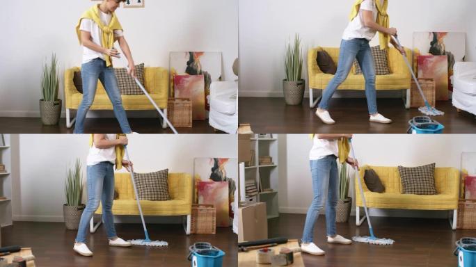 中年白人妇女用拖把在新家洗地板
