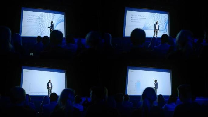 会议舞台: 演讲者展示新产品，谈论性能，神经网络，人工智能，大数据和机器学习。现场商务活动，观众鼓掌