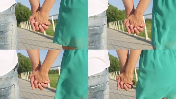 特写: 情侣在公园浪漫散步时的双手特写镜头