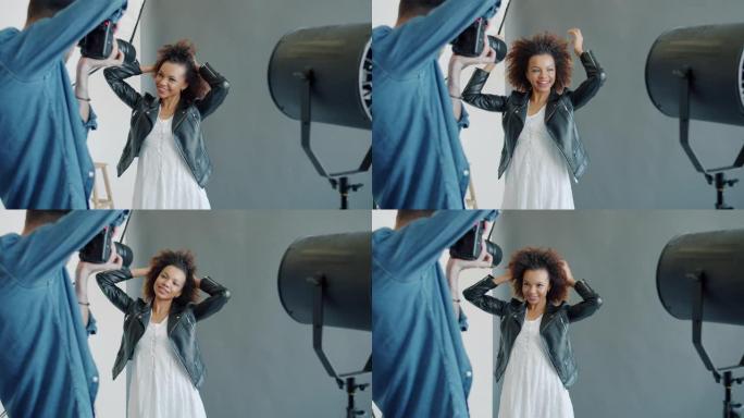 摄影师在工作室拍摄快乐的美国黑人女孩模特