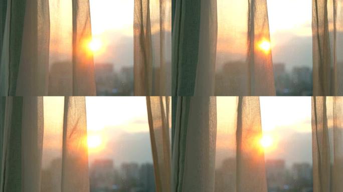 日出时的窗帘窗外太阳早晨太阳升起