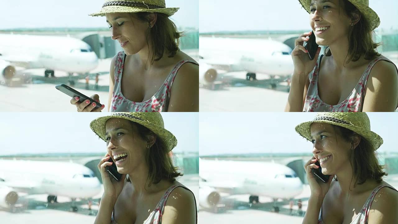 美丽的年轻女孩在机场，看着航班时刻表，戴着草帽，穿着连衣裙，微笑着。