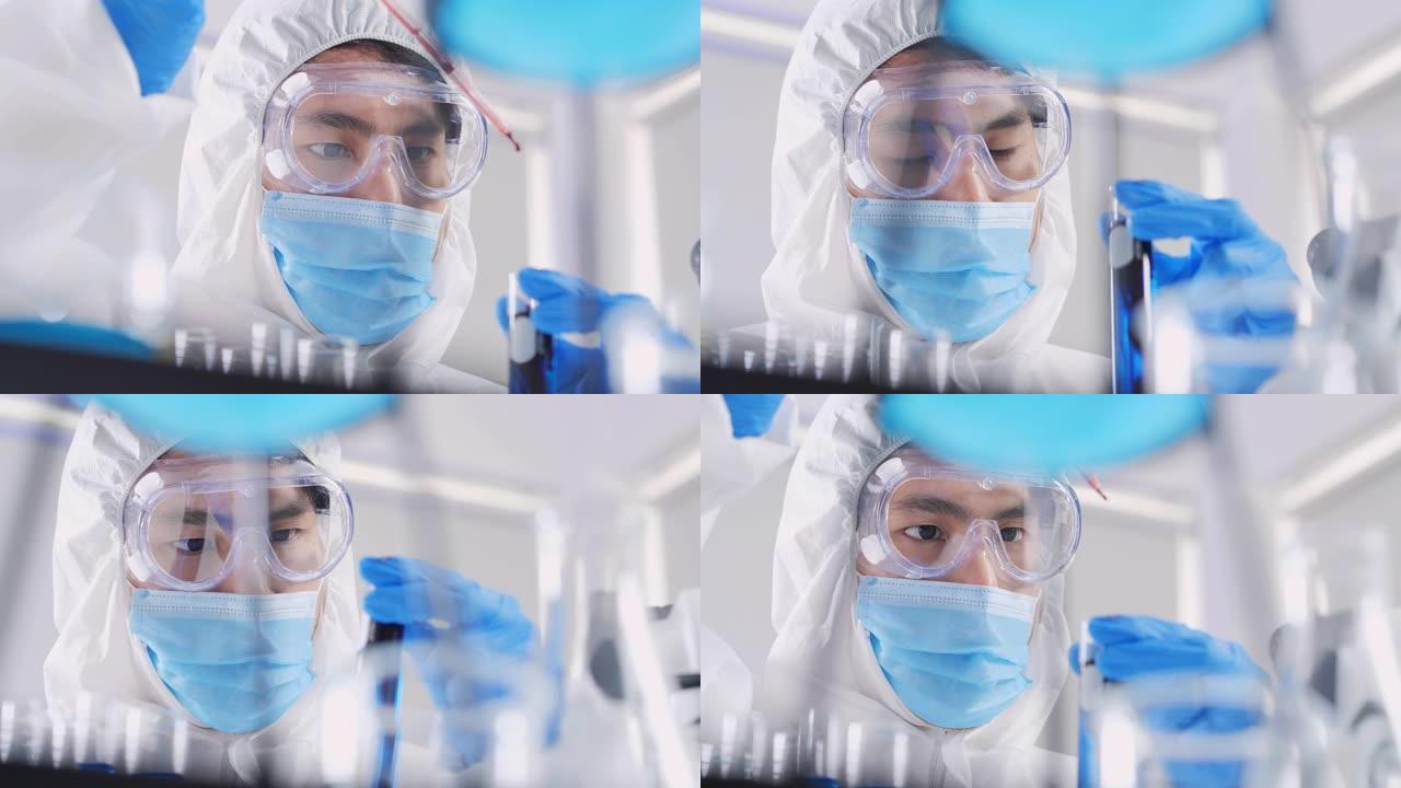 亚洲科学家对混合试管进行实验室测试的信心的特写，实验室中含有化学液体的实验对冠状病毒病毒或Covid