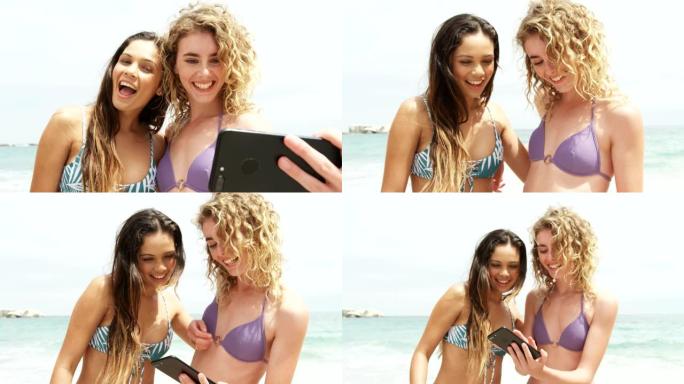 两个混血女性朋友在沙滩上用手机自拍的前视图4k