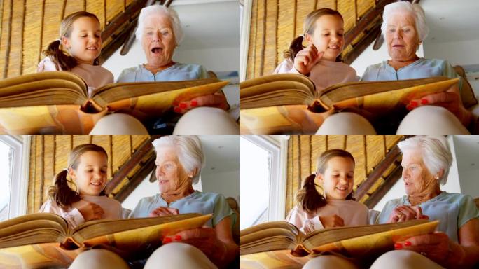 高加索祖母和孙女看相册4k的低角度视图