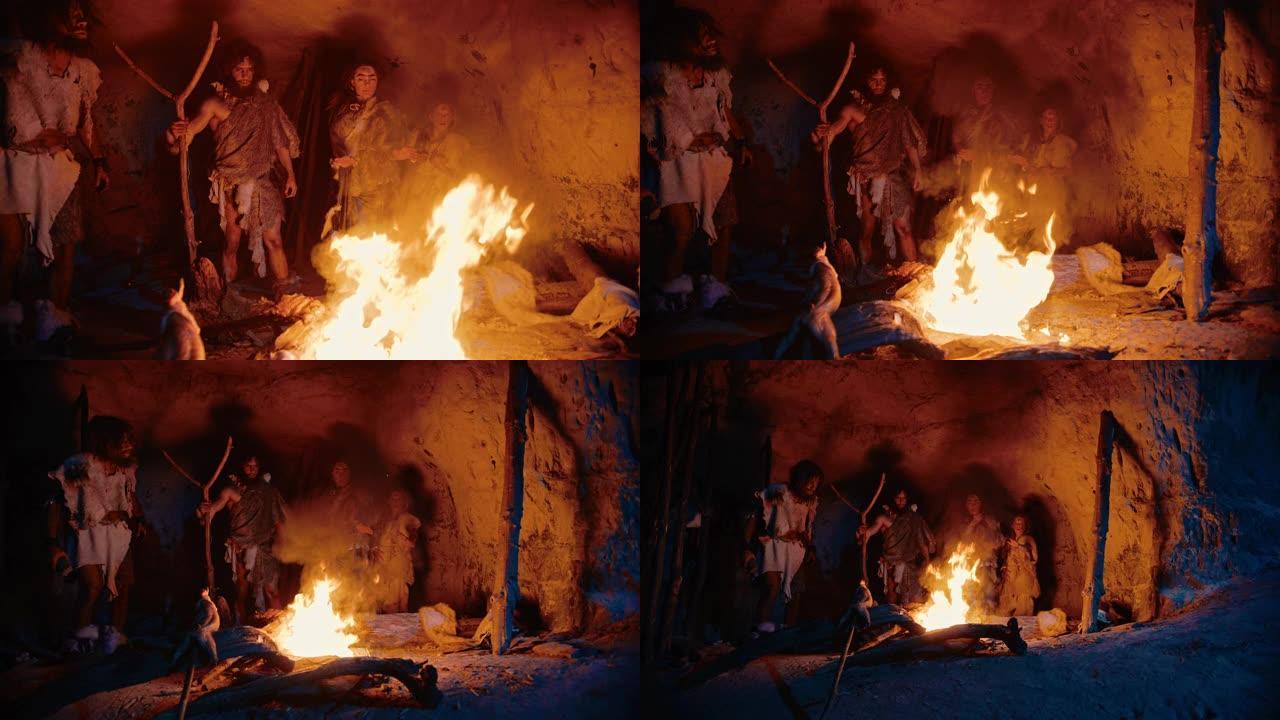 夜间，穿着动物皮的史前狩猎采集者部落站在洞穴外的篝火旁。尼安德特人/智人家庭在火附近进行异教宗教仪式