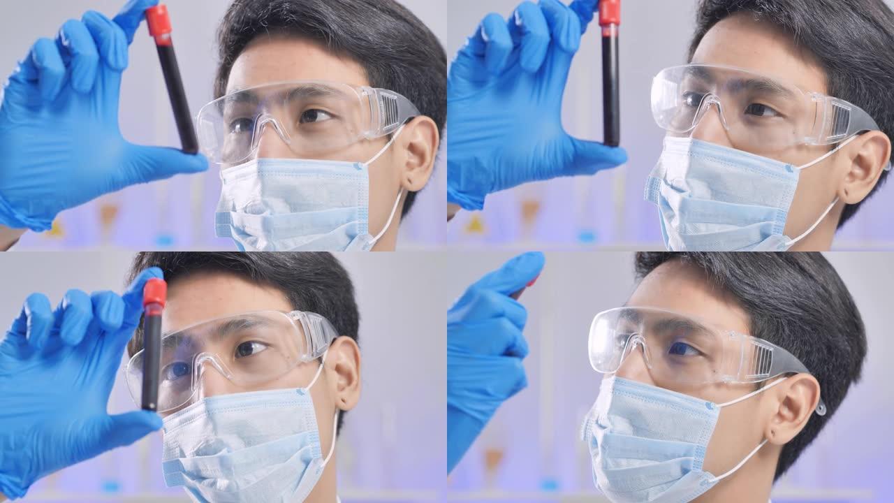 亚洲科学家的特写镜头希望在实验室中混合试管进行测试，在实验室中包含化学液体的实验对冠状病毒病毒或Co